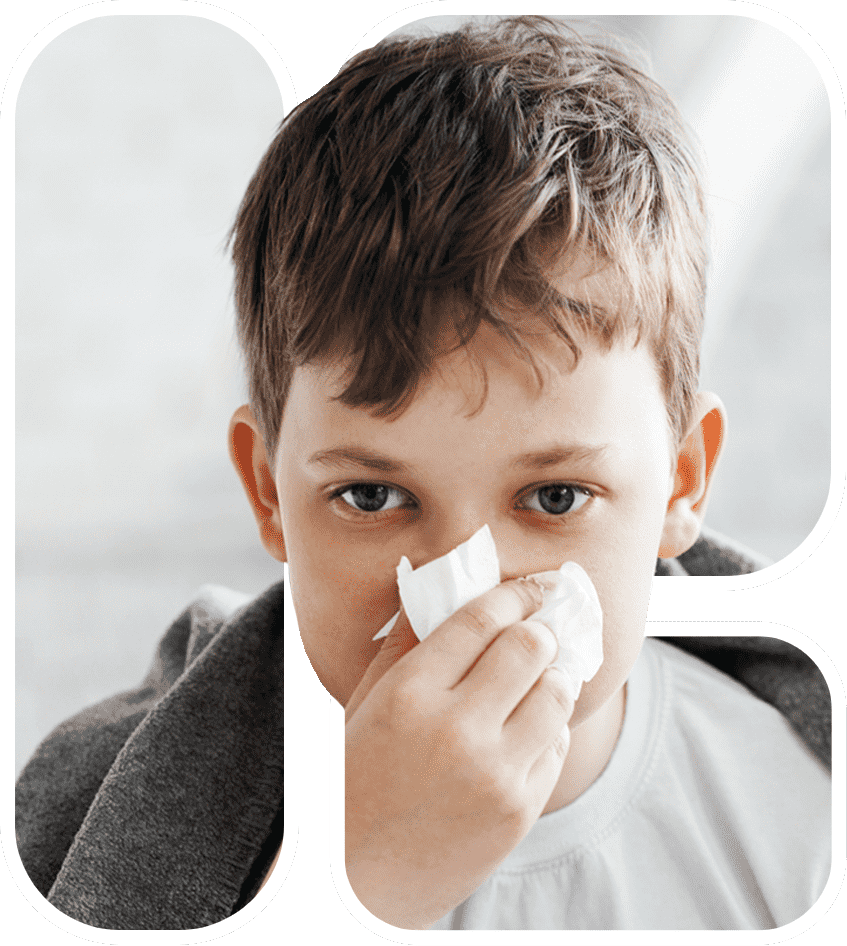 a kid wiping his nose after sneezing due to dust